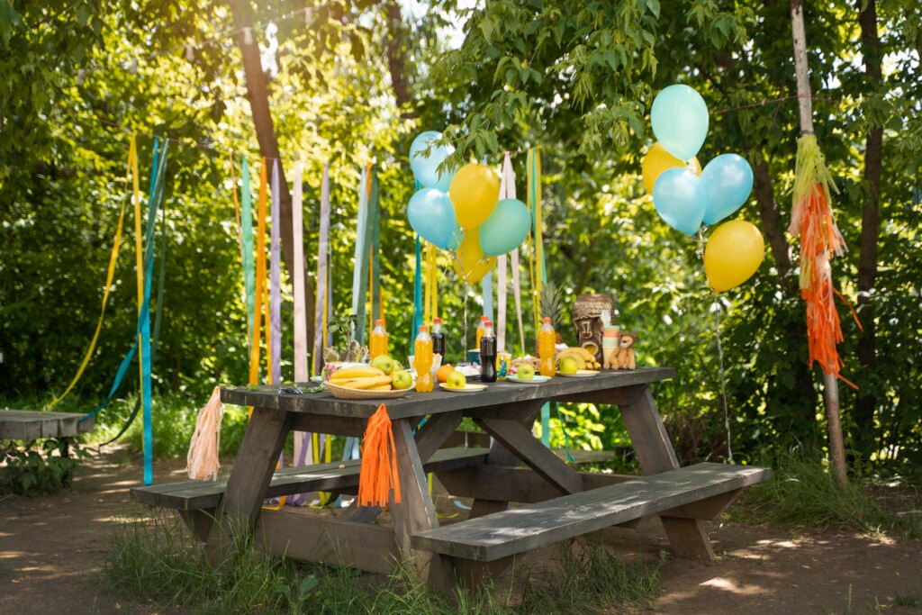 Outdoor BBQ set up with balloon decorations.